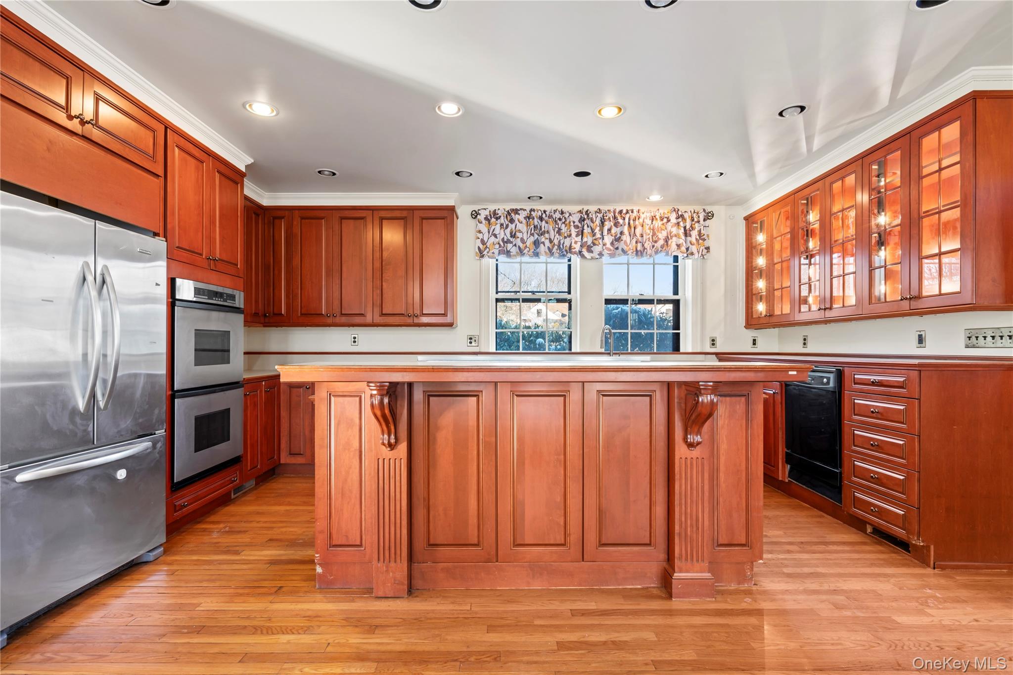 203 Store Hill Road Old Westbury, NY 11568 - Photo 14 of 50 a kitchen with stainless steel appliances granite countertop a refrigerator a sink dishwasher a stove with wooden cabinets and floor