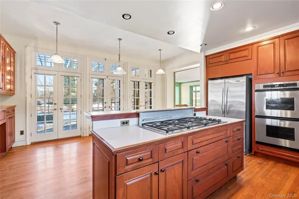 a kitchen with stainless steel appliances granite countertop a stove a refrigerator and a wooden cabinets