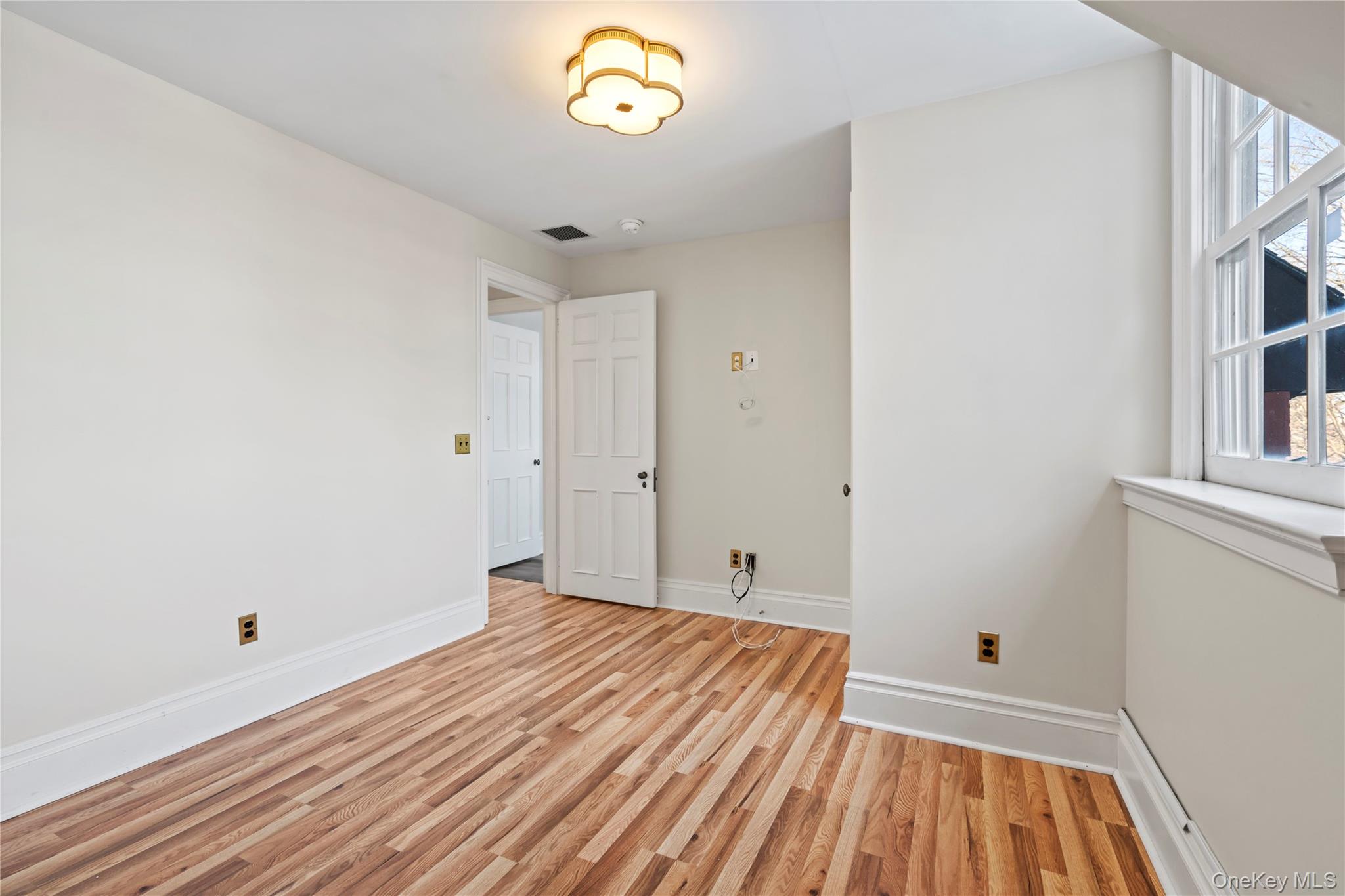 203 Store Hill Road Old Westbury, NY 11568 - Photo 22 of 50 a view of a room with wooden floor and a window