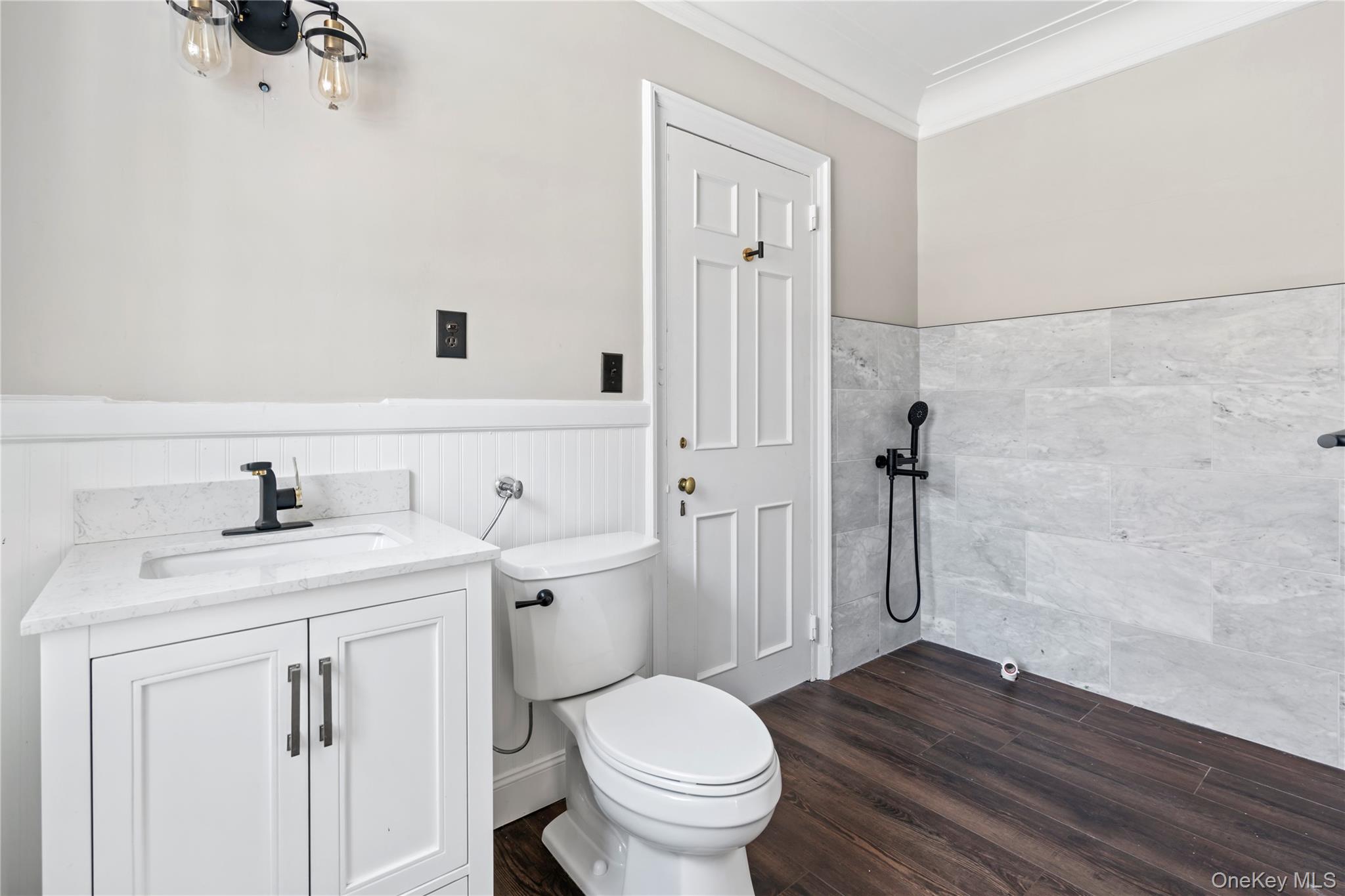 203 Store Hill Road Old Westbury, NY 11568 - Photo 29 of 50 a bathroom with a granite countertop toilet a sink a mirror and vanity