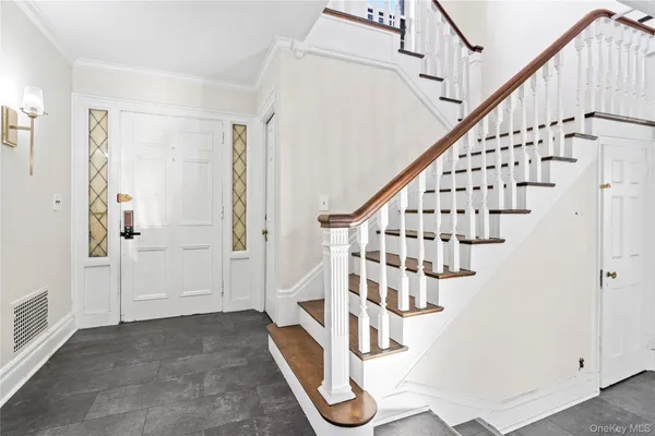 a view of entryway with wooden floor and stairs