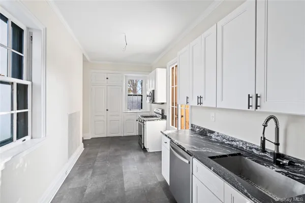 a kitchen with a sink stove and cabinets