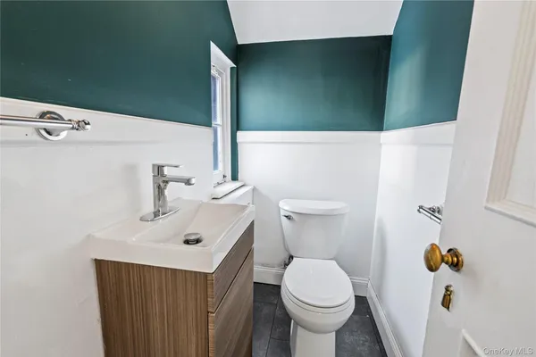 a bathroom with a sink toilet and mirror