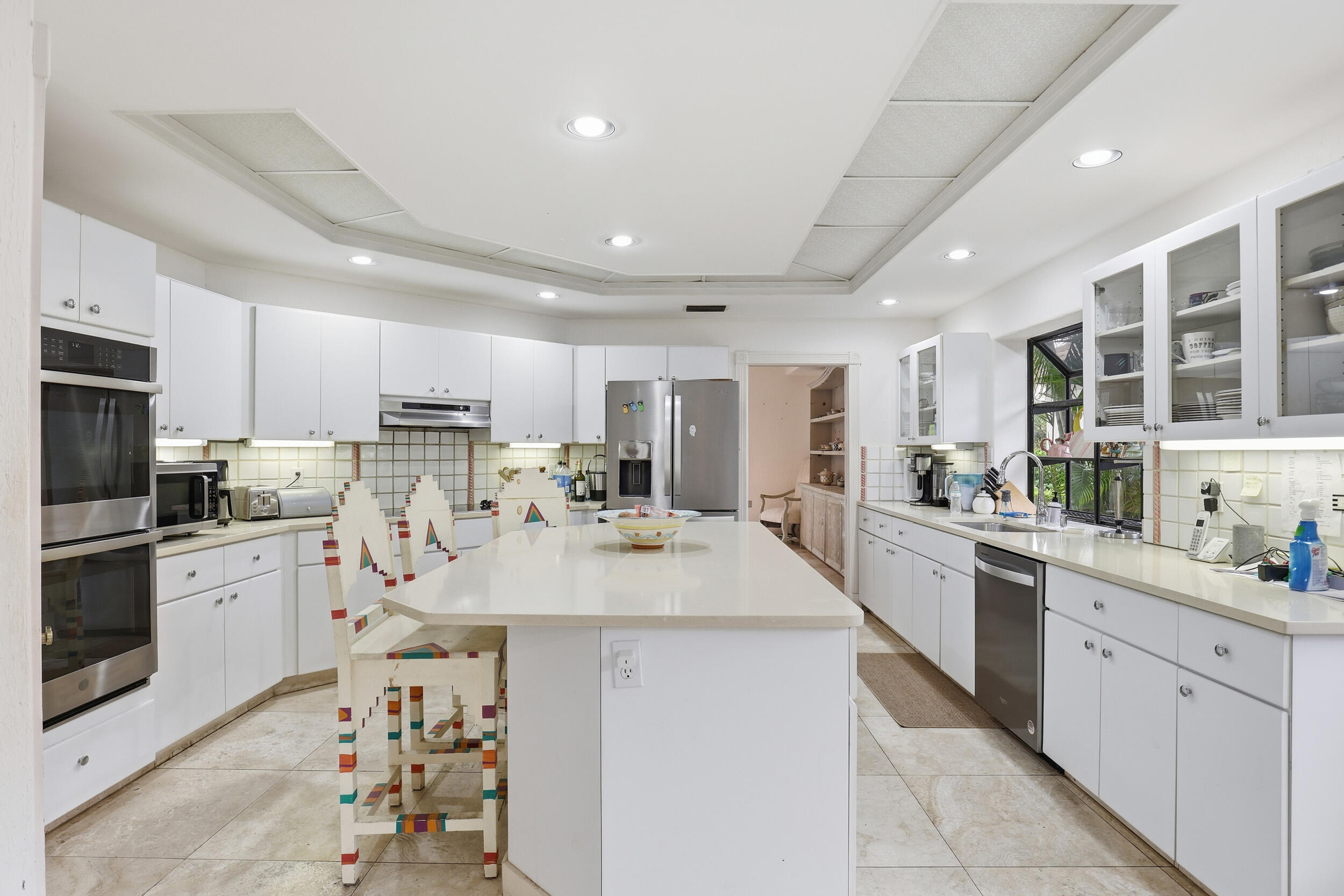 2248 Northwest 60th Street Boca Raton, FL 33496 - Photo 12 of 70 a large kitchen with kitchen island a sink stainless steel appliances and cabinets