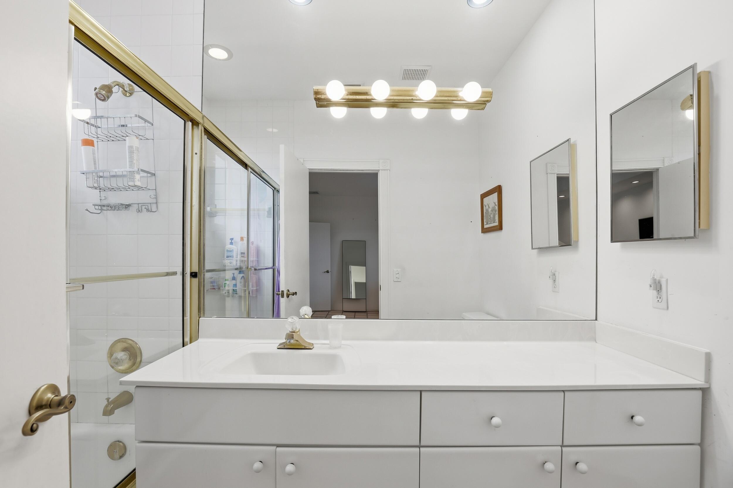 2248 Northwest 60th Street Boca Raton, FL 33496 - Photo 43 of 70 a bathroom with a sink vanity and mirror