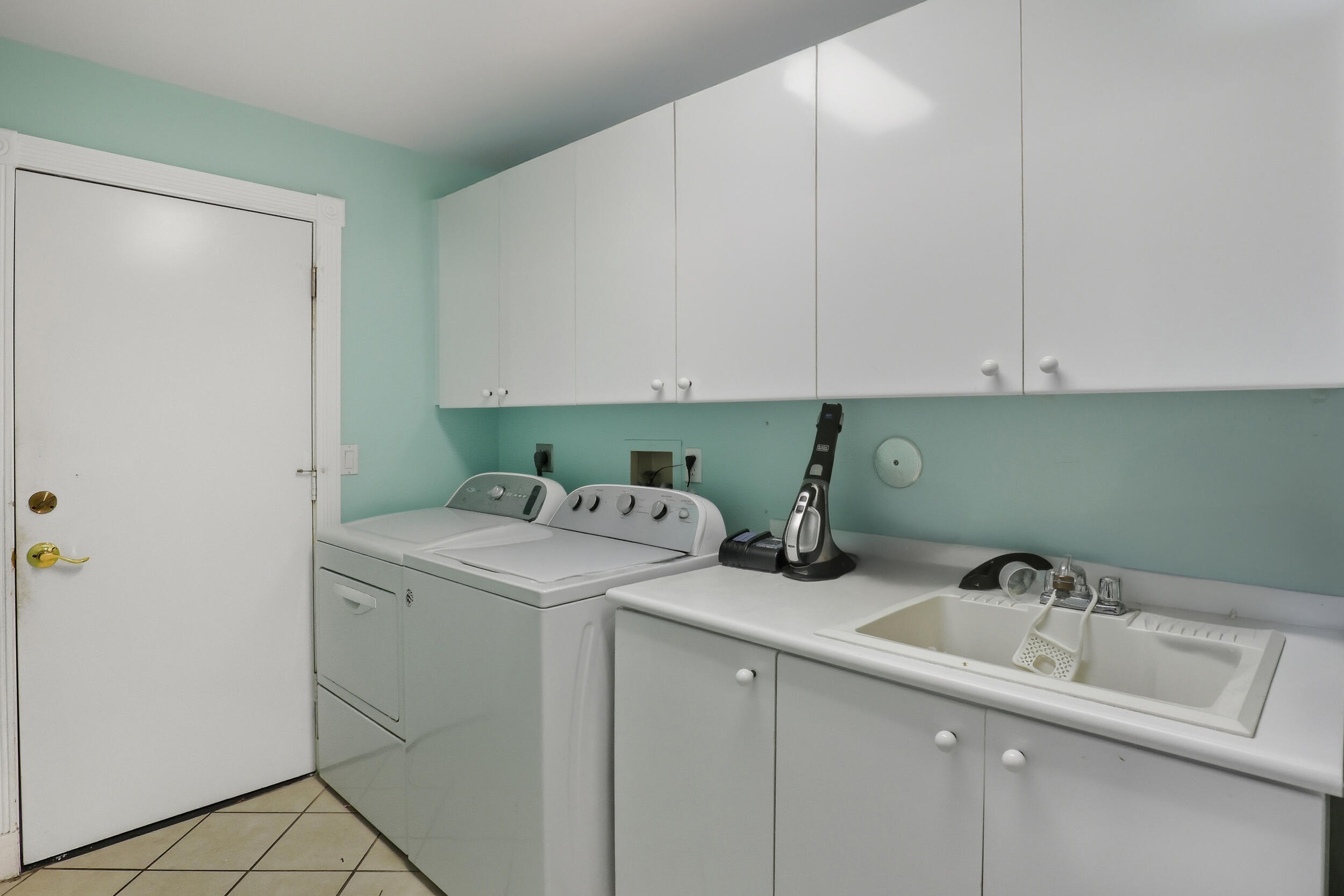 2248 Northwest 60th Street Boca Raton, FL 33496 - Photo 46 of 70 a utility room with a sink washer and dryer