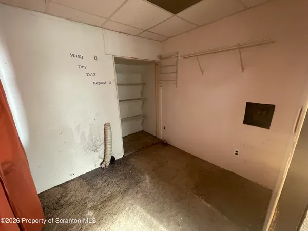 a view of storage and utility room with empty racks