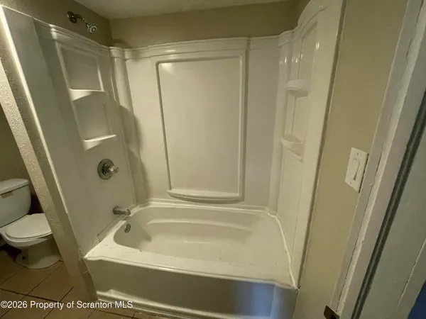 a bathroom with a tub and a shower