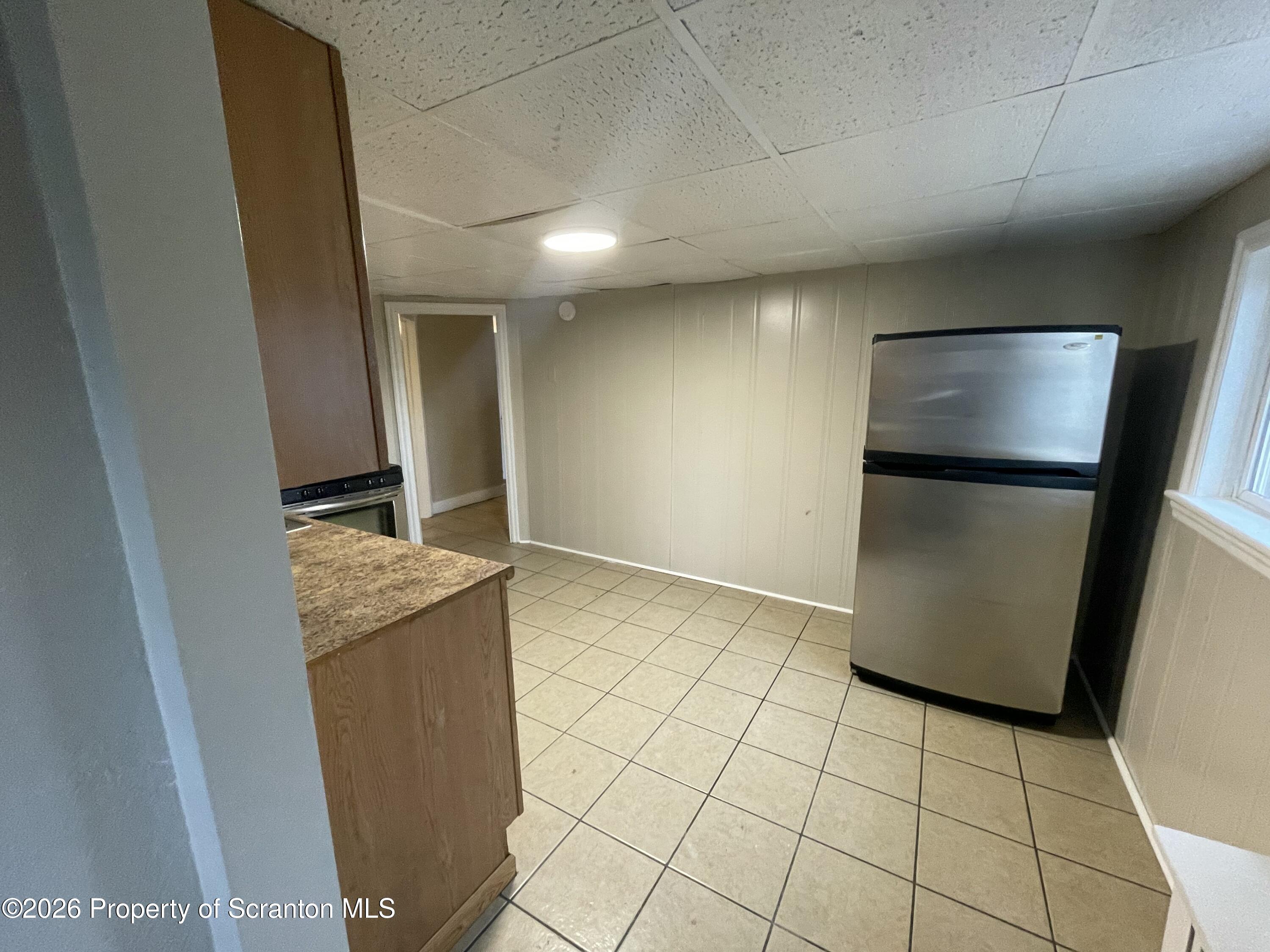 401 Putnam Street Scranton, PA 18508 - Photo 22 of 29 a view of a refrigerator in kitchen and an empty room