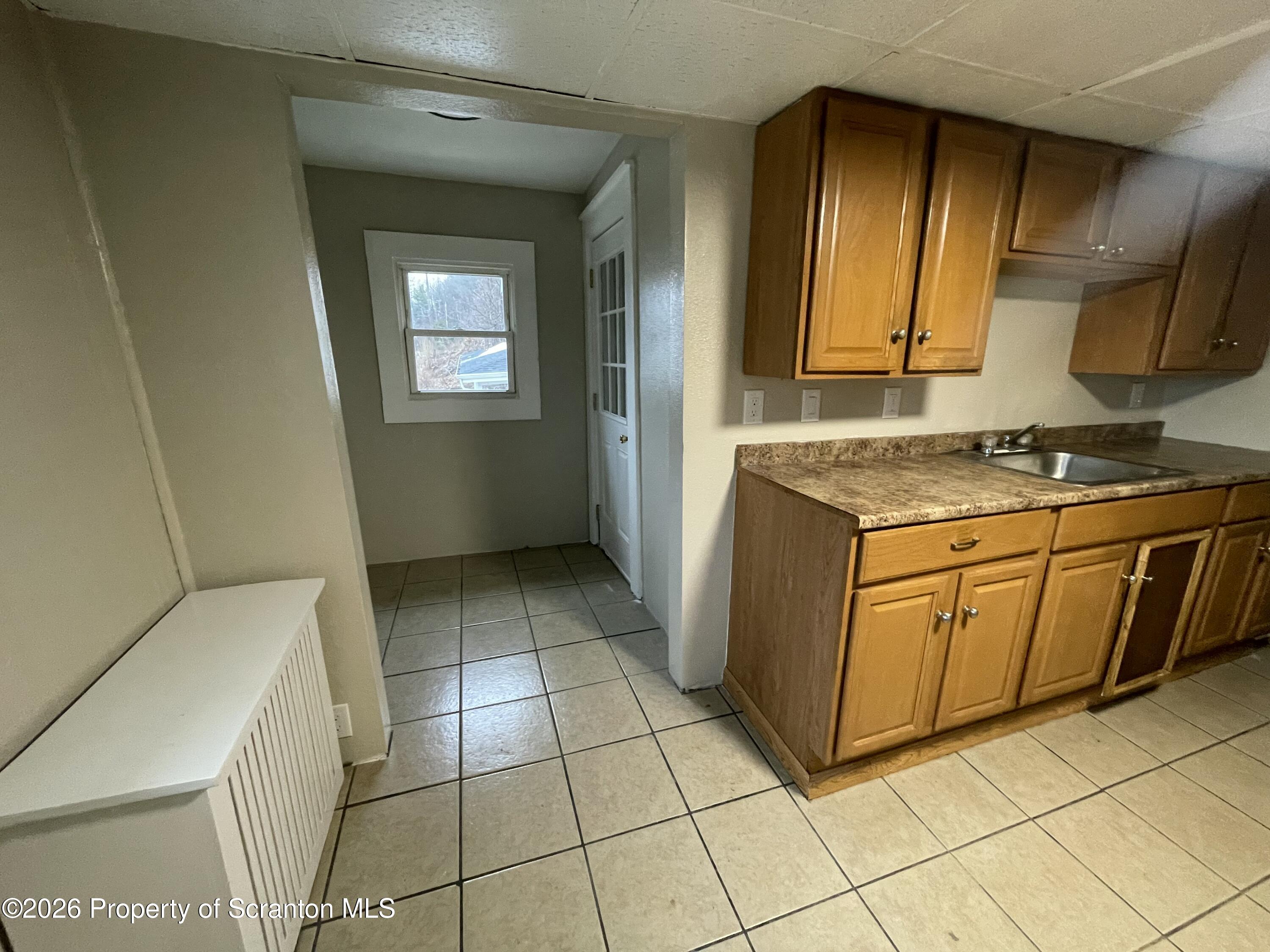 401 Putnam Street Scranton, PA 18508 - Photo 24 of 29 a kitchen with a stove top oven cabinets and a refrigerator