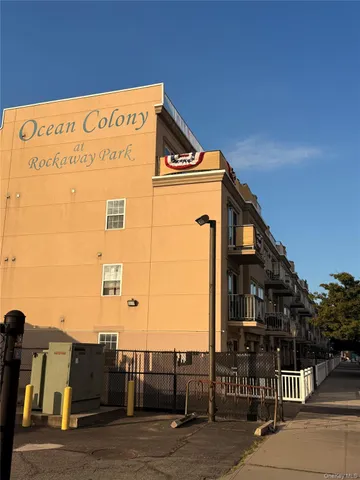 a view of a building with wooden fence