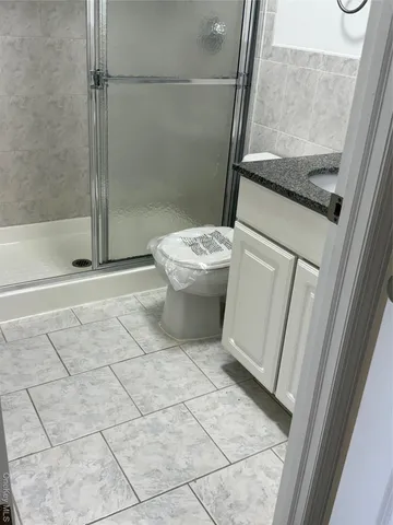 a bathroom with a sink a toilet and a shower