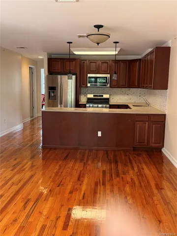 a view of kitchen with wooden floor