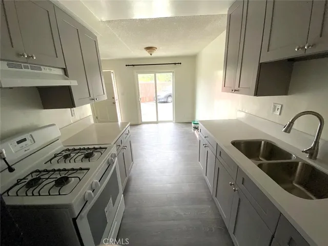 a kitchen that has a sink and a stove