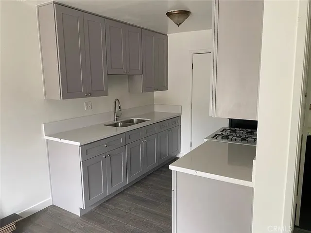 a kitchen with a sink and a refrigerator
