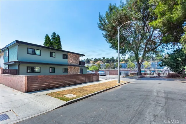a view of house with swimming pool and sitting area