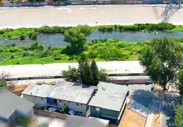an aerial view of a house with a yard and lake view