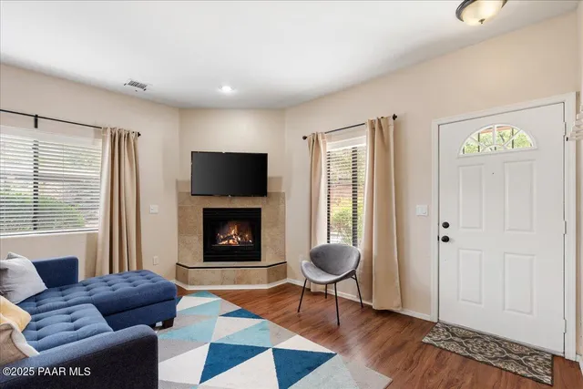 a living room with furniture a fireplace and a window