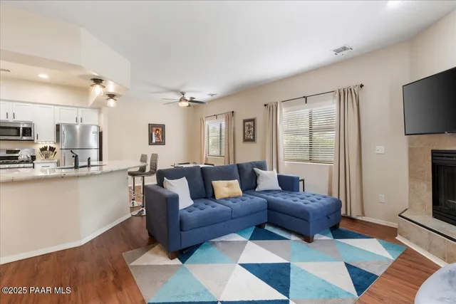 a living room with furniture a flat screen tv and a fireplace