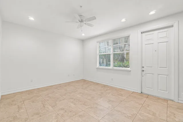 an empty room with windows and closet