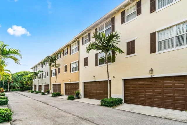 a front view of a building with a yard and garage