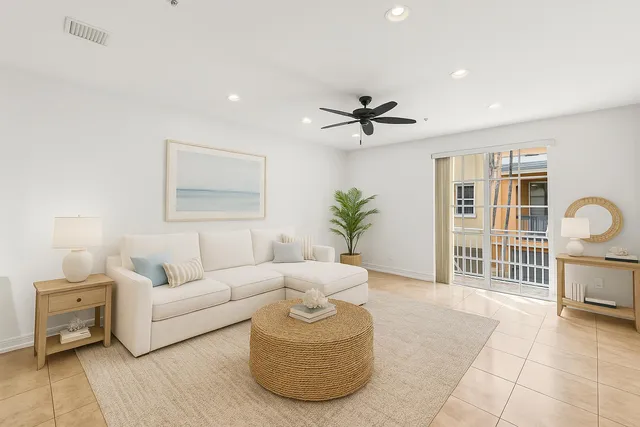 a living room with furniture and a ceiling fan