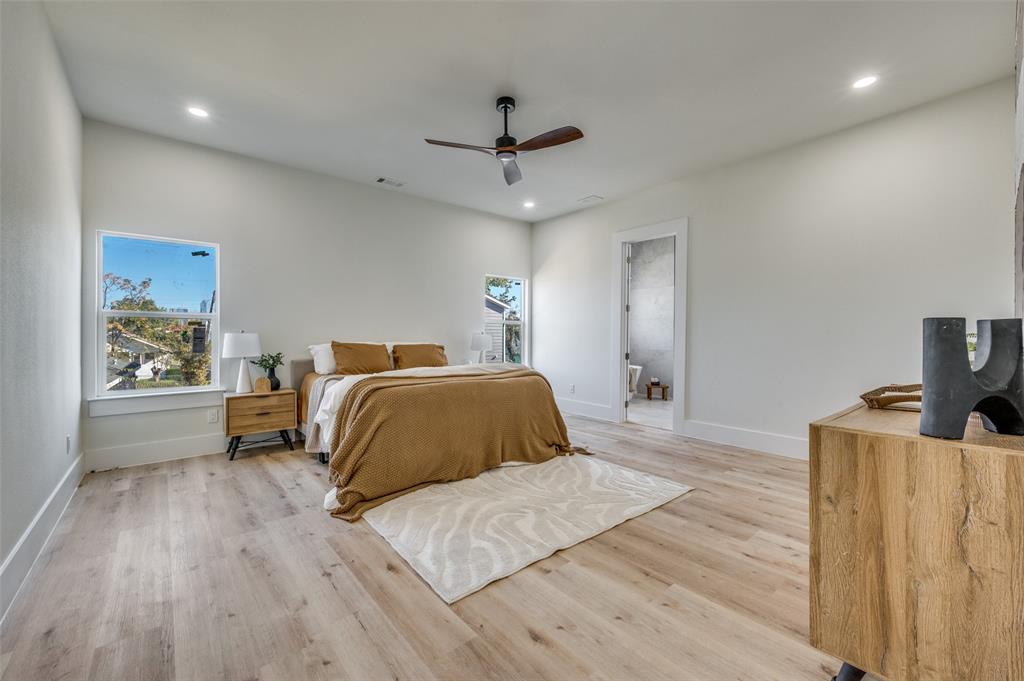 3314 Navaro Street Dallas, TX 75212 - Photo 14 of 24 a bedroom with a bed and wooden floor
