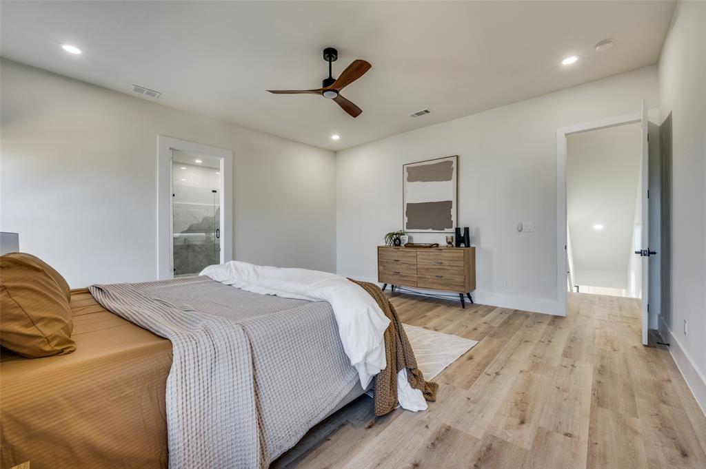 3314 Navaro Street Dallas, TX 75212 - Photo 15 of 24 a bedroom with a bed and a chandelier