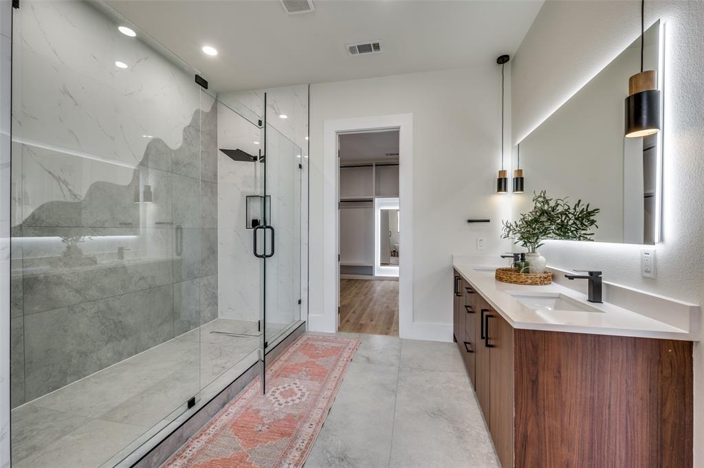 3314 Navaro Street Dallas, TX 75212 - Photo 17 of 24 a spacious bathroom with a granite countertop sink a mirror and shower