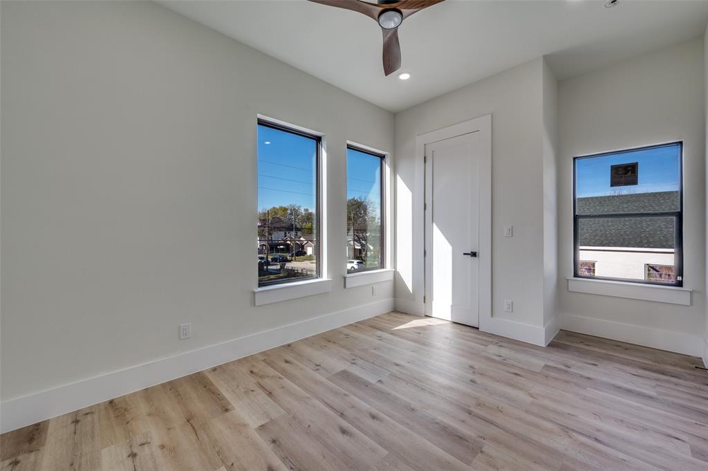 3314 Navaro Street Dallas, TX 75212 - Photo 21 of 24 a view of an empty room with a window and wooden floor