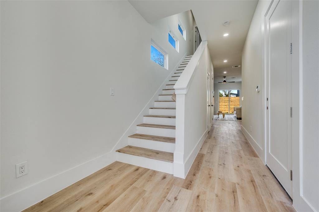 3314 Navaro Street Dallas, TX 75212 - Photo 3 of 24 a view of a hallway with wooden floor and stairs