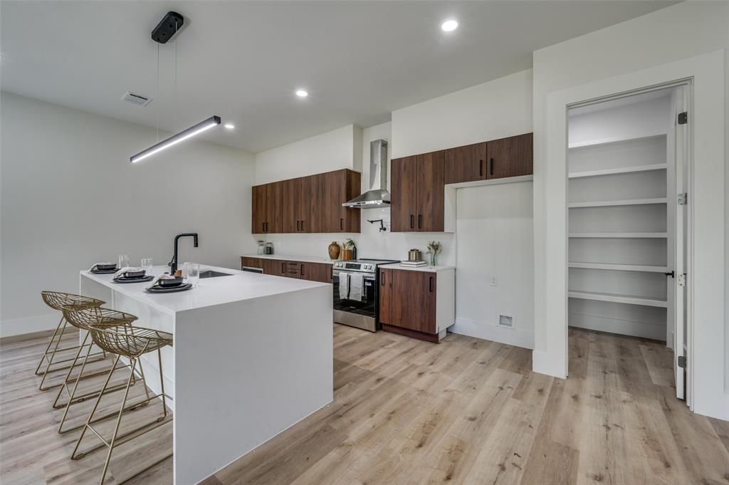 3314 Navaro Street Dallas, TX 75212 - Photo 7 of 24 a kitchen with a sink a refrigerator and cabinets