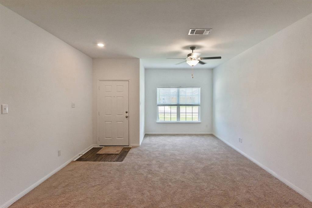 16429 Farmhouse Lane Elgin, TX 78621 - Photo 3 of 22 Entry foyer with wood-finish flooring, recessed lighting, and a white paneled door
