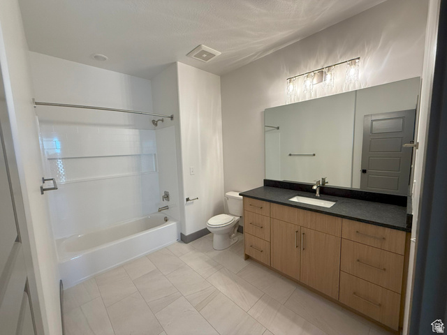 8087 South 615 East, Unit 3 Sandy, UT 84070 - Photo 17 of 23 Bathroom featuring a light wood-finish vanity with ample storage, a dark countertop, and a rectangular undermount sink