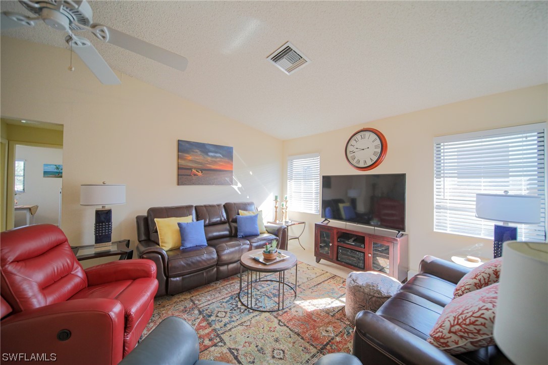 5774 Samoa Drive Bokeelia, FL 33922 - Photo 17 of 43 a living room with furniture a flat screen tv and a wall clock