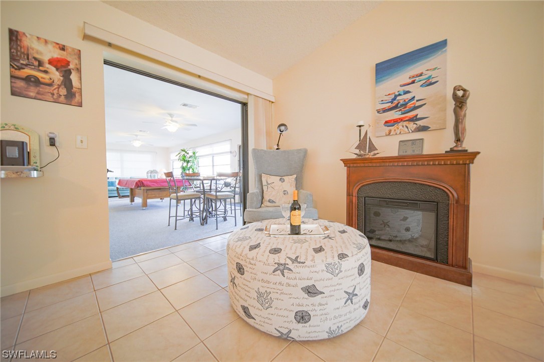 5774 Samoa Drive Bokeelia, FL 33922 - Photo 21 of 43 a living room with furniture a fireplace and a table
