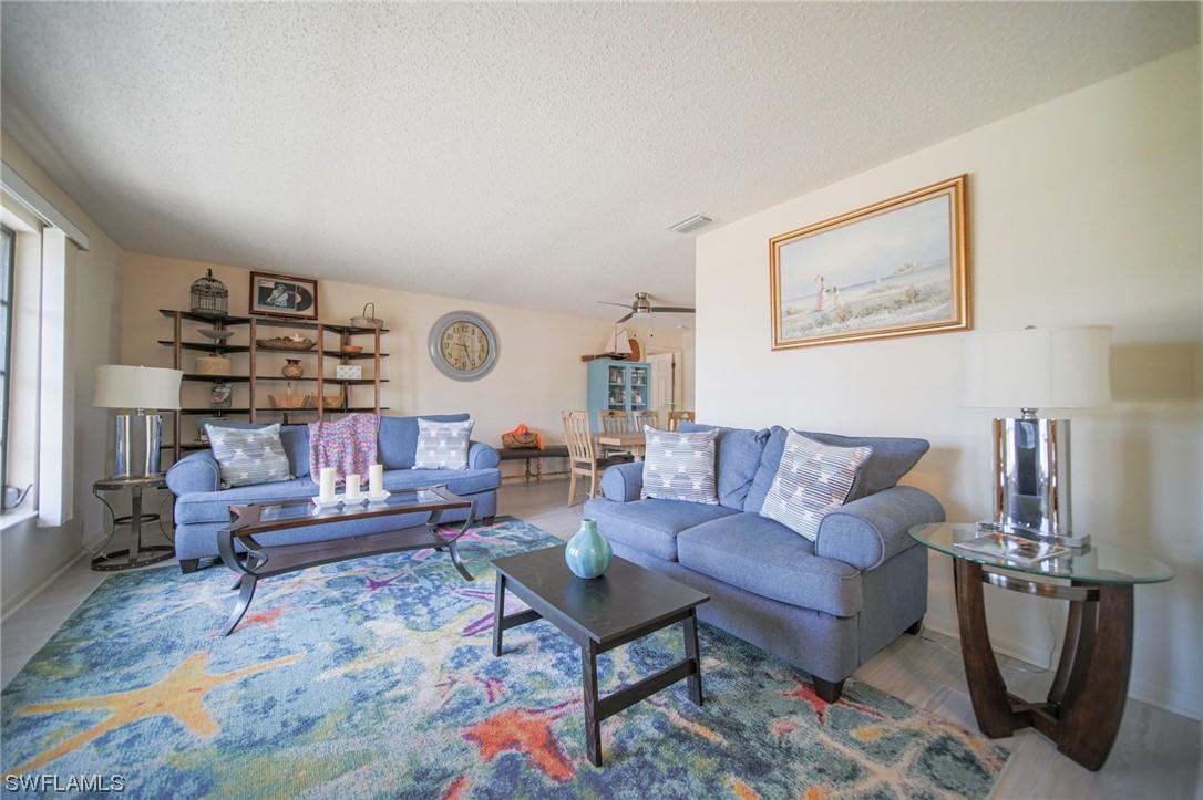 5774 Samoa Drive Bokeelia, FL 33922 - Photo 5 of 43 a living room with furniture and wooden floor