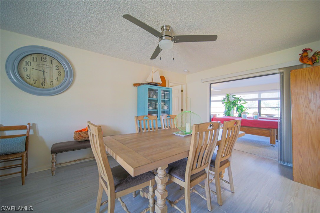 5774 Samoa Drive Bokeelia, FL 33922 - Photo 9 of 43 a view of a dining room with furniture window and wooden floor