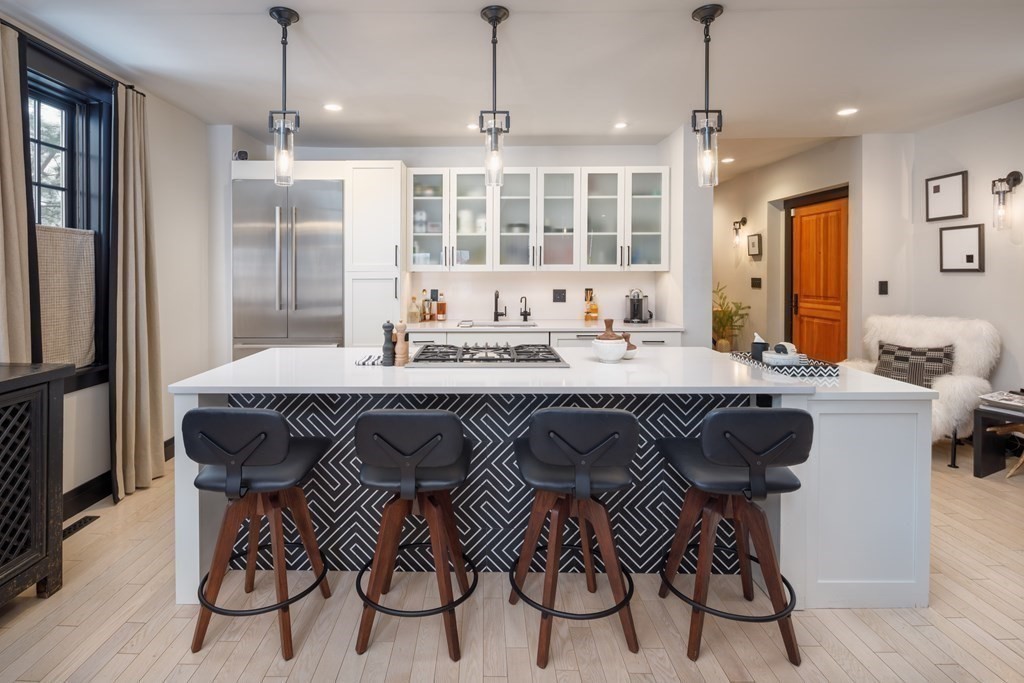 a kitchen with a sink and chairs
