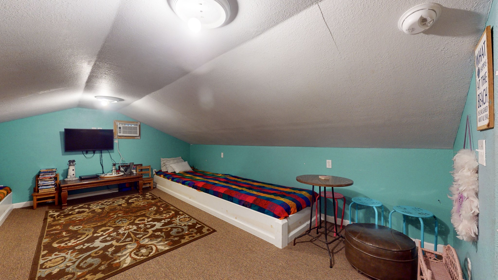 982 Kirks Road Port Bolivar, TX 77650 - Photo 34 of 39 a living room with a bed and a flat screen tv