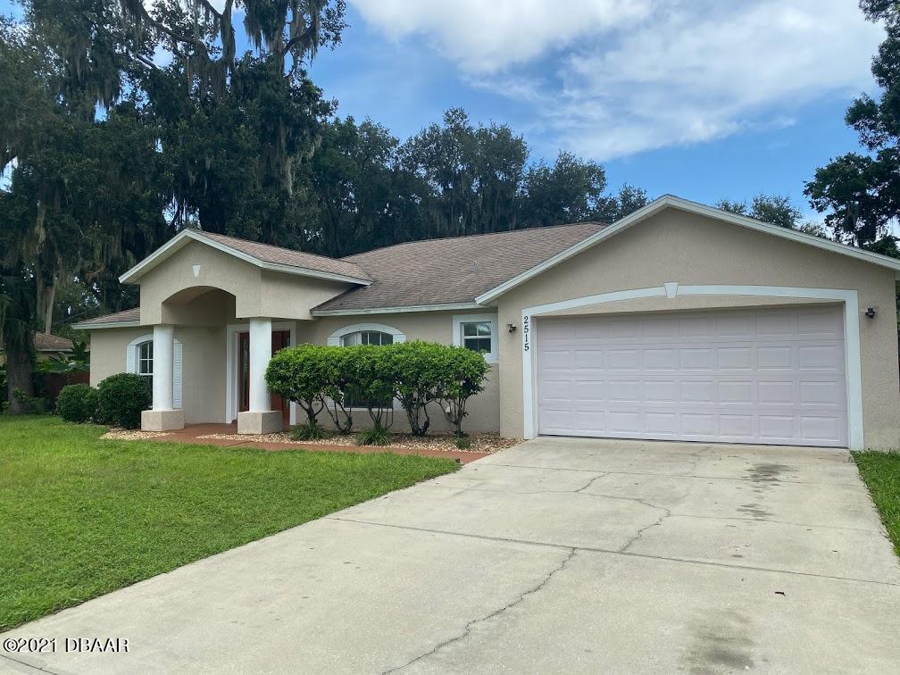 2515 Kumquat Drive Edgewater, FL 32141 - Photo 1 of 1 a front view of a house with a yard and garage