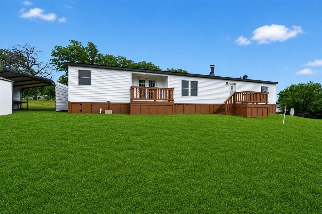 134 Classic Country Court Springtown, TX 76082 - Photo 29 of 33 a front view of house with yard and green space
