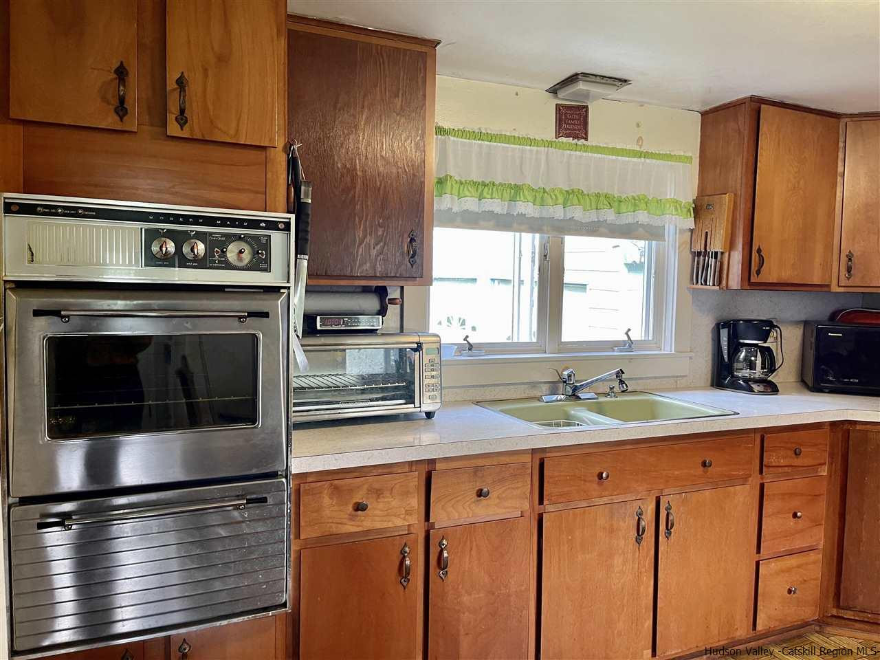 6277 County Rt 36 Denver, NY 12421 - Photo 13 of 27 a kitchen with granite countertop stainless steel appliances a stove sink and cabinets