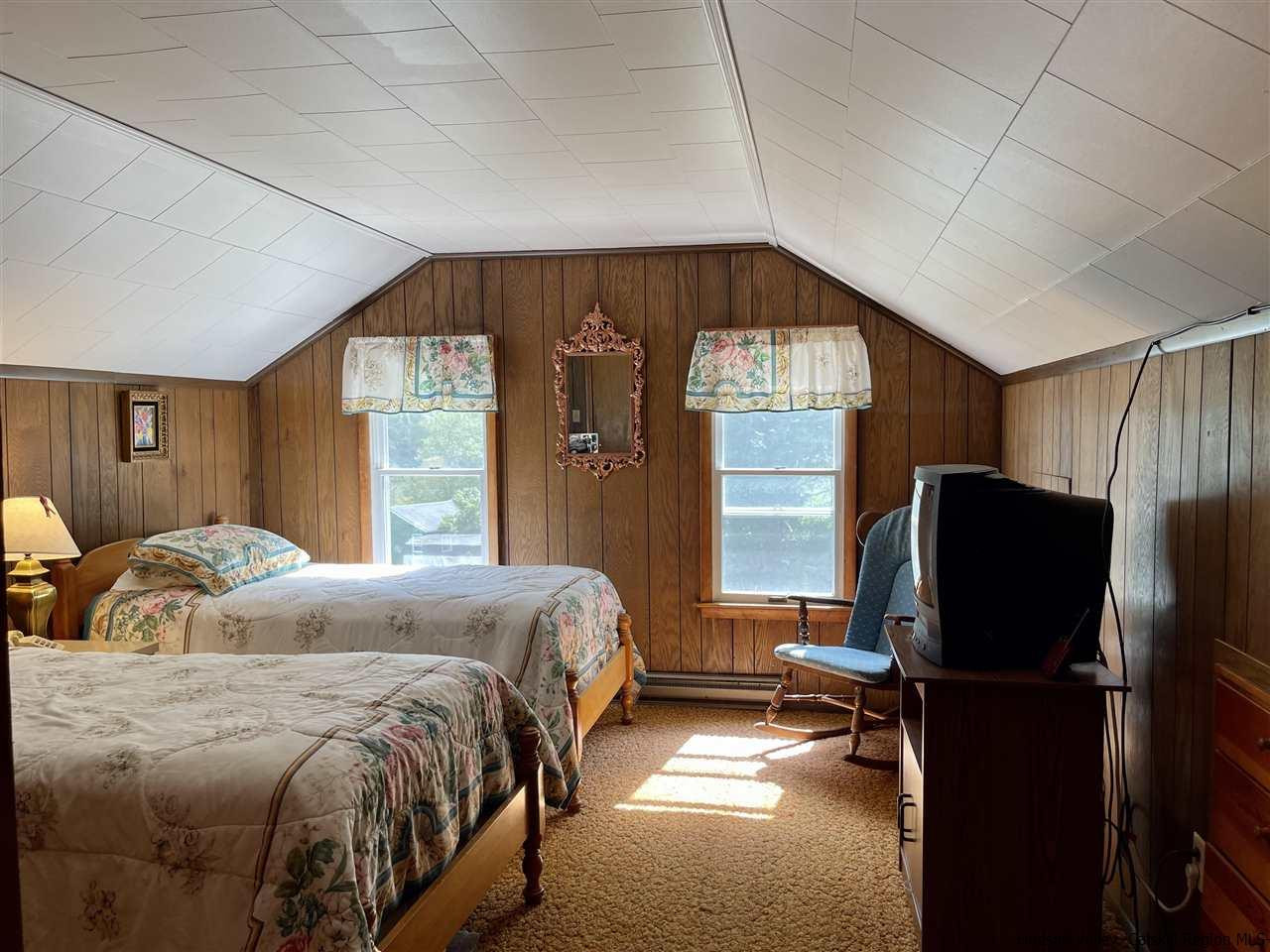 6277 County Rt 36 Denver, NY 12421 - Photo 15 of 27 a bedroom with a bed tv and window