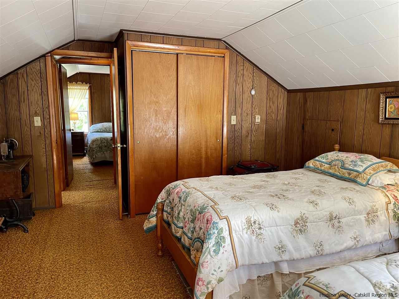 6277 County Rt 36 Denver, NY 12421 - Photo 16 of 27 a bedroom with a bed and a large mirror