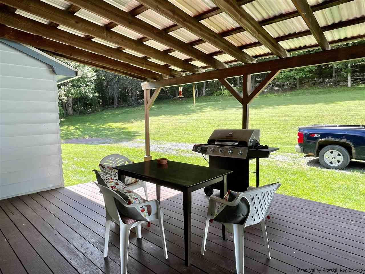 6277 County Rt 36 Denver, NY 12421 - Photo 6 of 27 a view of a deck with table and chairs with wooden floor