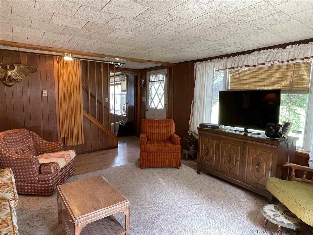 6277 County Rt 36 Denver, NY 12421 - Photo 8 of 27 a living room with furniture and a flat screen tv