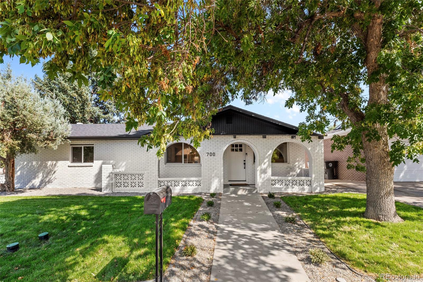 700 Busch Street Longmont, CO 80501 - Photo 1 of 27 a front view of a house with garden