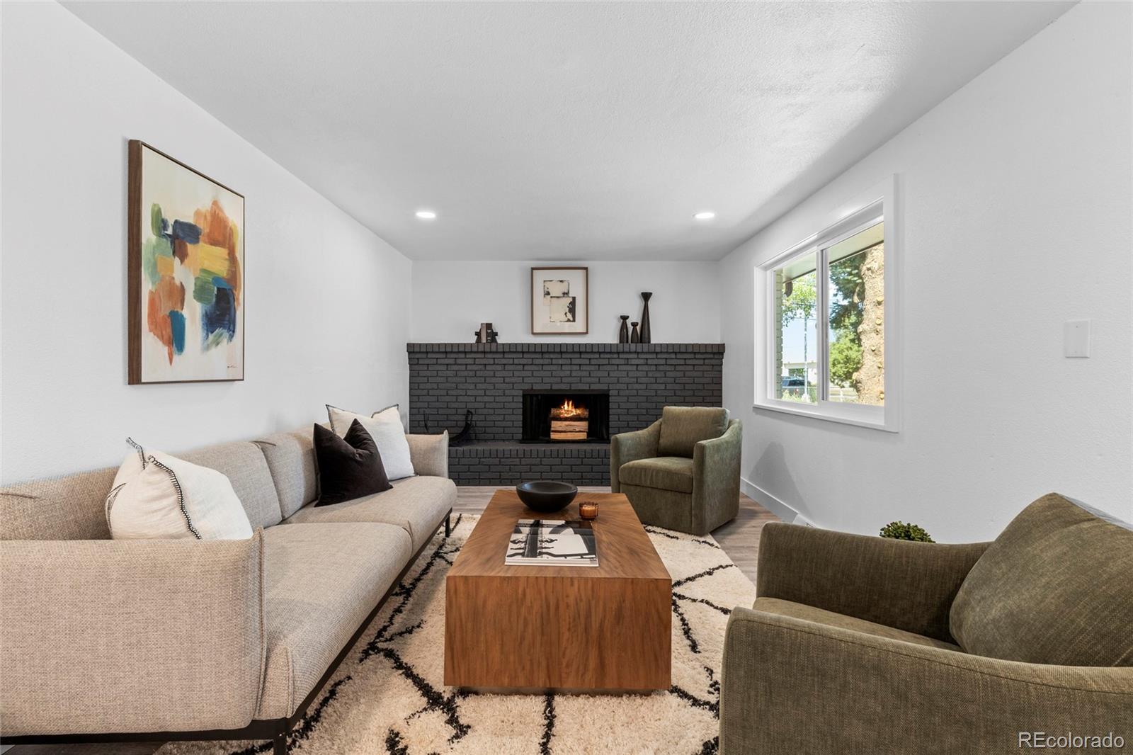 700 Busch Street Longmont, CO 80501 - Photo 12 of 27 a living room with furniture and a fireplace