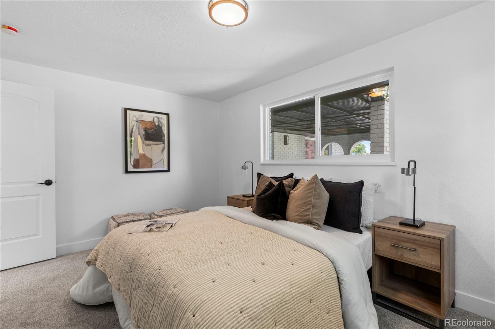 700 Busch Street Longmont, CO 80501 - Photo 13 of 27 a bedroom with a bed and wooden floor